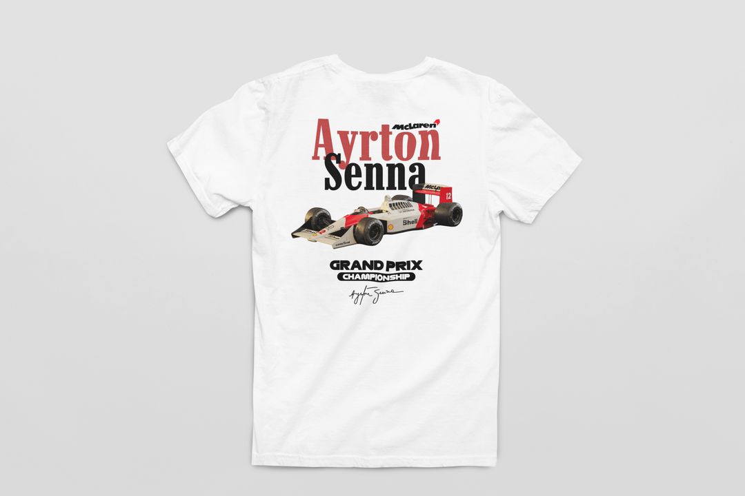 White t-shirt with Ayrton Senna Formula 1 car graphic on a gray background