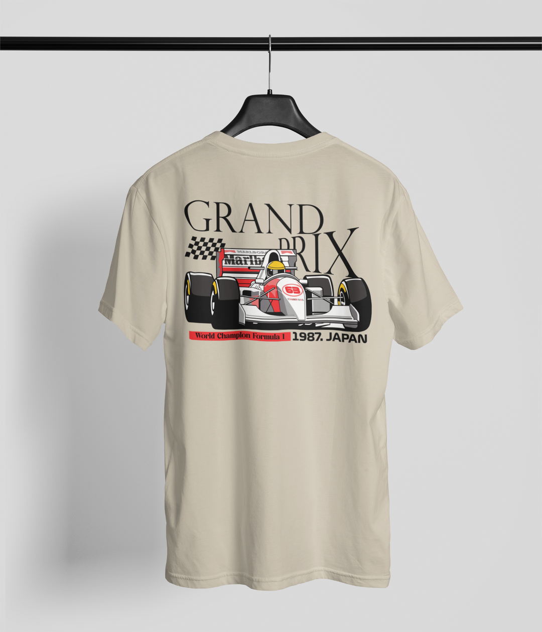Beige t-shirt with Formula 1 car graphic and text on a hanger against a light gray background