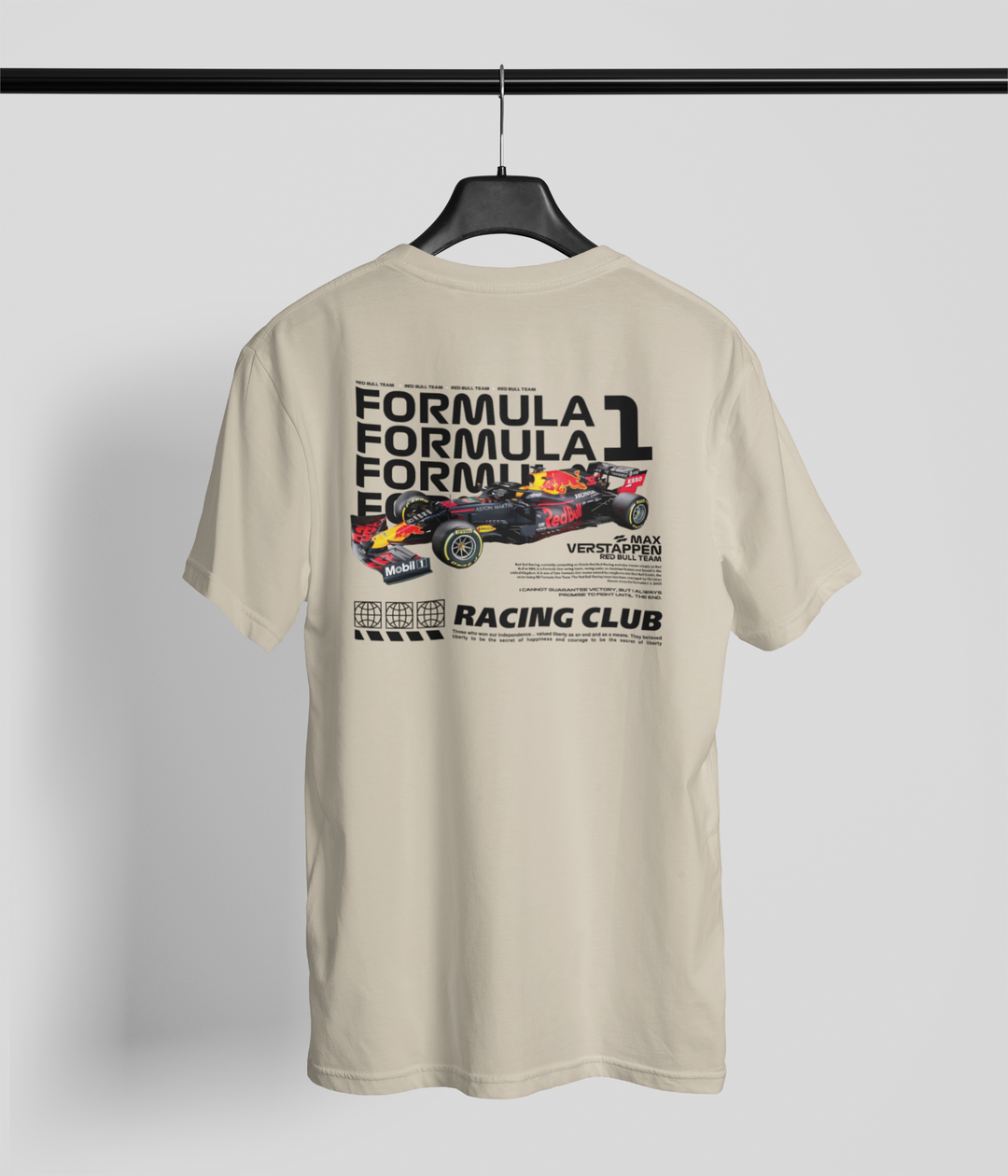 Beige t-shirt with Formula 1 graphic on a hanger against a gray background