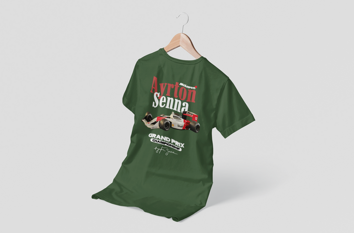 Green t-shirt with Ayrton Senna graphic on a hanger against a white background