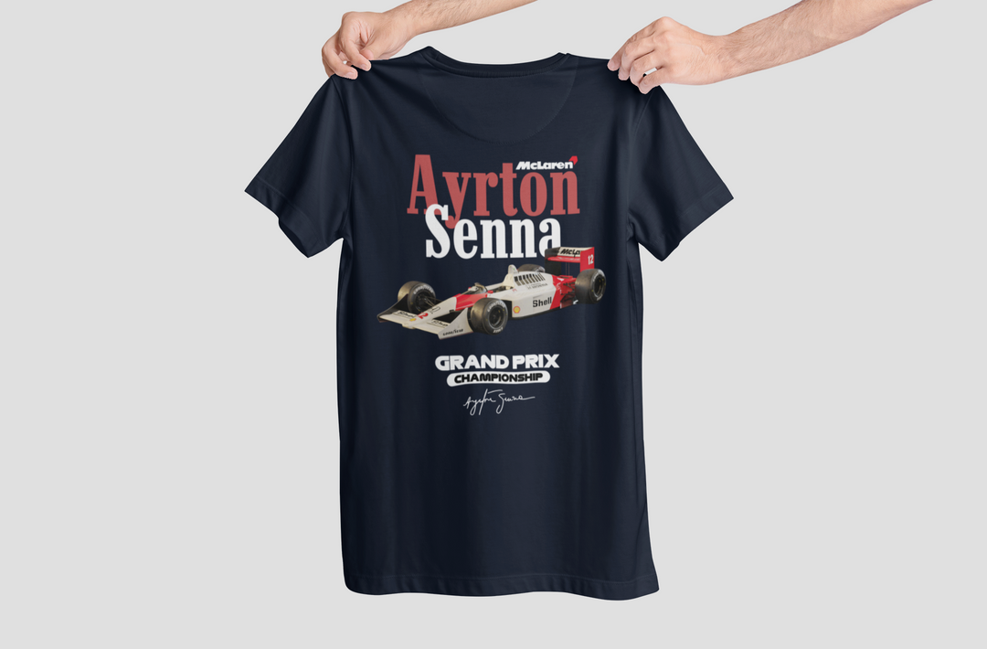 Navy blue t-shirt with Ayrton Senna Grand Prix design held by a person on a light gray background