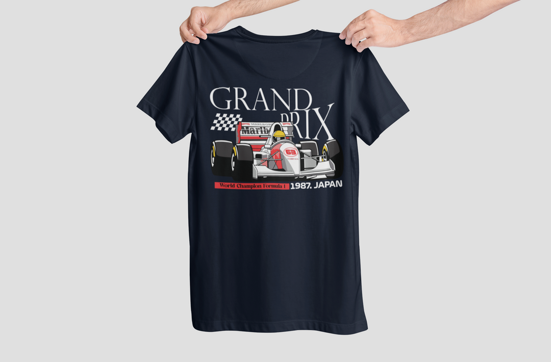 Black t-shirt with race car graphic and text held by a person on a light gray background